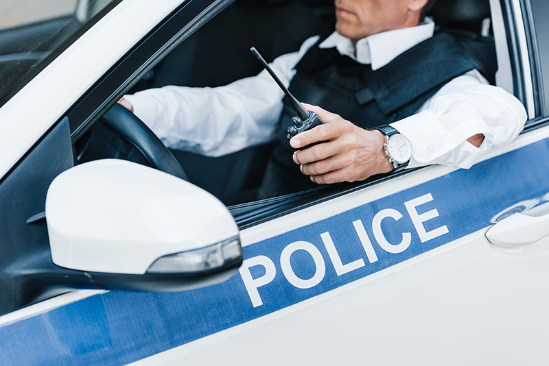 police-officer-with-radio Police officer equipped with a radio for critical law enforcement communication.
